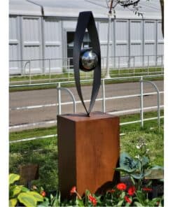 Contemporary abstract sculpture with a reflective metallic sphere, displayed outdoors at The Kildare Gallery.
