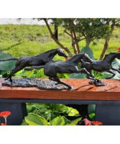 Bronze sculpture of three running horses displayed outdoors at The Kildare Gallery in Ireland.