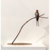 Elegant bird sculpture on a branch, exhibited at The Kildare Gallery, showcasing contemporary art.