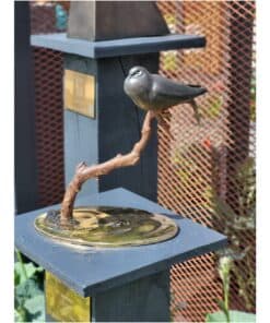 Aviary sculpture of a bird perched on a twisted branch, displayed at The Kildare Gallery.