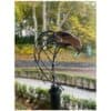 Intricate eagle sculpture blending metal and bronze art, displayed outdoors in scenic Kildare setting.