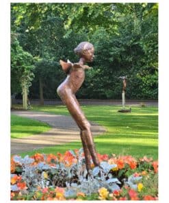 Bronze sculpture of a girl in a park, surrounded by colourful flowers and lush greenery.