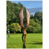 Elegant bronze sculpture of a figure with wings in a lush garden setting at The Kildare Gallery, Ireland.