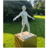 Bronze sculpture of a dynamic, expressive male figure outdoors at The Kildare Gallery, captured in lush garden setting.