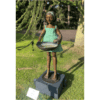 Whimsical bronze sculpture of a girl holding a basket outdoors, part of The Kildare Gallery collection.