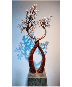Sculpture of intertwined rusty metal trees with white spherical leaves, modern art piece at The Kildare Gallery.