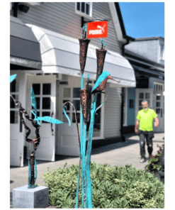 Bronze and turquoise sculpture of a bird and abstract shapes outside The Kildare Gallery, Ireland.