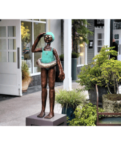Bronze sculpture of a young girl with swimsuit and goggles, outside The Kildare Gallery.
