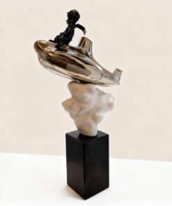 Silver abstract sculpture with black figure on top at The Kildare Gallery.