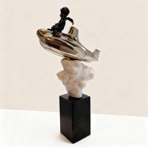 Silver abstract sculpture with black figure on top at The Kildare Gallery.