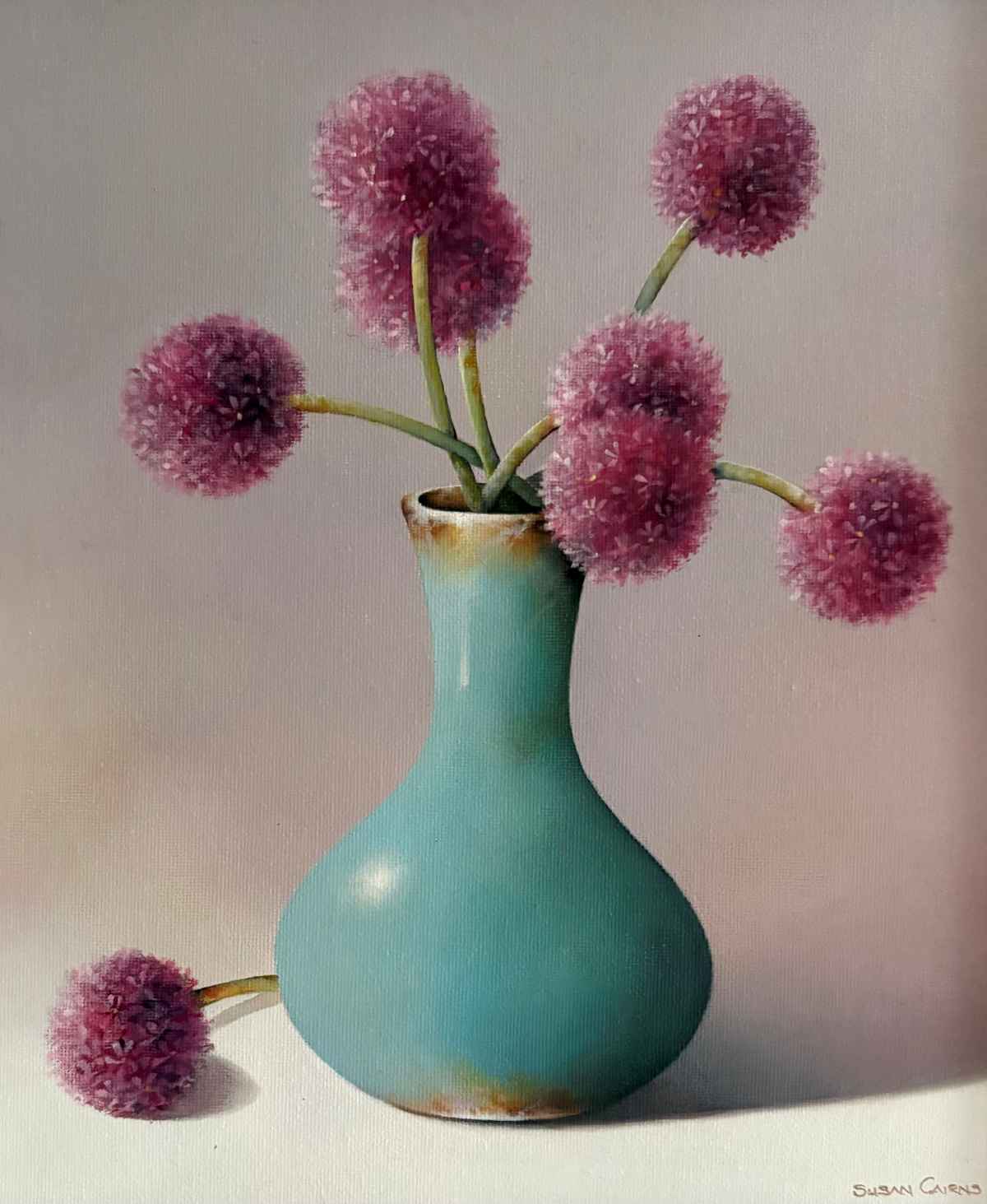 Vibrant pink allium flowers in a turquoise ceramic vase, showcasing contemporary art and floral arrangements at The Kildare Gallery.