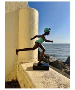 Vibrant sculpture of a runner woman by the seaside at The Kildare Gallery, Irish contemporary art exhibition.